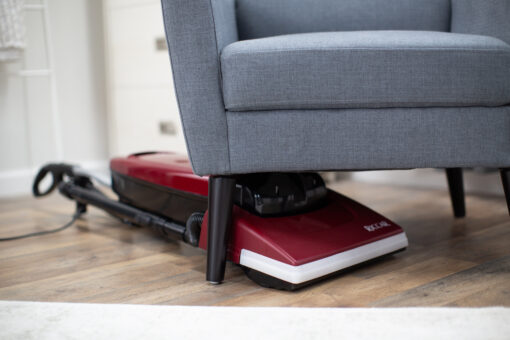 Riccar R21 Spirit Upright Vacuum, vacuuming under chairs
